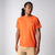 Gray background, male model wearing the JOOLA Men's Court Short Sleeve tee in poppy red.