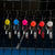 The full set of Agassi and Pro IV colorful table tennis paddle keychains on a black background.