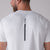 Close up image showing the JOOLA logo that runs down the middle of the back of a Men's Court Short Sleeve shirt, white.