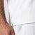 Close up image of the JOOLA logo tag on the side of a JOOLA men's club polo, white.