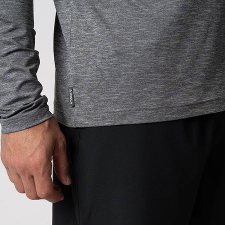 Close up image of the raised JOOLA logo on the side of a JOOLA men's quarter zip pullover, charcoal heather.