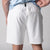 Close up of the back of a pair of JOOLA men's woven shorts, 7-inch inseam, white.