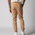 Gray background, image of a male model showing the back of a pair of JOOLA Men's Club Joggers, latte color.