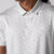 Gray background, close up image of the buttons, collar and raised JOOLA trinity logo on the front of a JOOLA Men's Club Printed Polo, Safari Leopard pattern.
