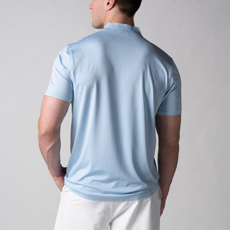 Gray background, image showing the back of a male model wearing the JOOLA Men's Court Polo, Blue Breeze.