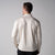 Gray background, image showing the back of a male model wearing a JOOLA Men's Quarter Zip Pullover, sandstone color.