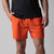 Gray background, close up image of the front of a pair of JOOLA Men's Woven Shorts, 5-inch, poppy red.