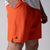 Gray background, close up image of the JOOLA Men's Woven Shorts, 7-inch, poppy red color.