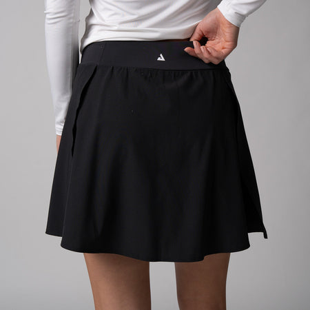 Gray background, close up image of the JOOLA trinity logo on the back of a JOOLA women's pickleball skort, black.