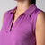 Gray background, close up on the printed collar on a JOOLA women's club sleeveless polo, passion purple.