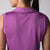 Gray background, image of the back of a female model wearing a JOOLA women's club sleeveless polo, purple passion.