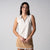 Gray background, image of a female model wearing the JOOLA women's club sleeveless polo, sandstone color.