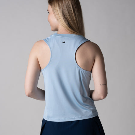 Gray background, image of the back of a female model wearing a JOOLA women's court tank, blue breeze color.