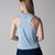 Gray background, image of the back of a female model wearing a JOOLA women's court tank, blue breeze color.