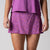 Gray background, close up image of the JOOLA women's pickleball printed skort, passion purple.