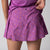 Gray background, close up on the back of the JOOLA women's pickleball printed skort, passion purple.
