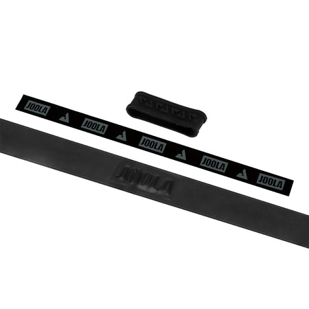 White background, image of black JOOLA Fel-Tec Pure Grip unrolled with a black JOOLA rubber band pictured.