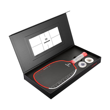 Pickleball paddle and ball set in a black box with a visible brand logo.