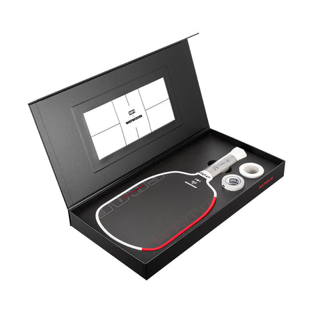 Pickleball paddle and ball set in a black box with a visible brand logo.