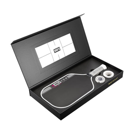Pickleball paddle and ball set in a black box with a visible brand logo.