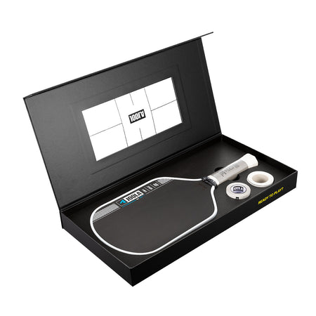 Pickleball paddle and ball set in a black box with a visible brand logo.