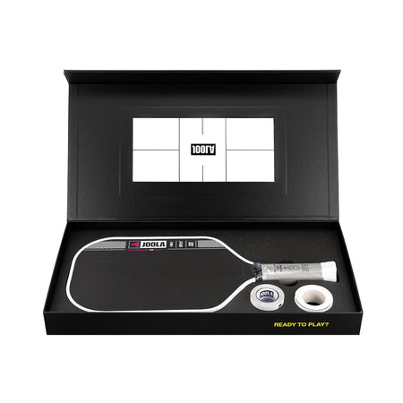 Pickleball paddle and ball set in a black box with a visible brand logo.