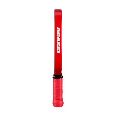 White background, image of the Agassi wordmark on the side of a Agassi Pro Miniature paddle.