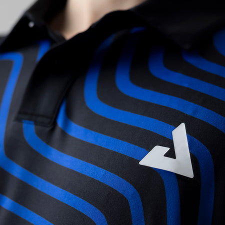 Close up on the white JOOLA Trinity logo on the chest of the JOOLA Table Tennis Team Polo.