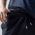Close up on the waist band of a pair of JOOLA table tennis shorts, black.