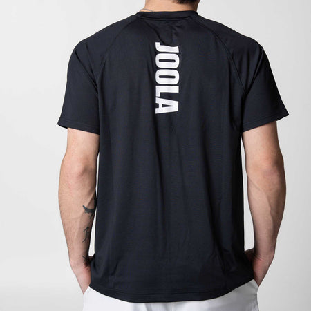White background, image showing the back of a JOOLA Court Short Sleeve Shirt, black with white lettering.