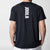 White background, image showing the back of a JOOLA Court Short Sleeve Shirt, black with white lettering.