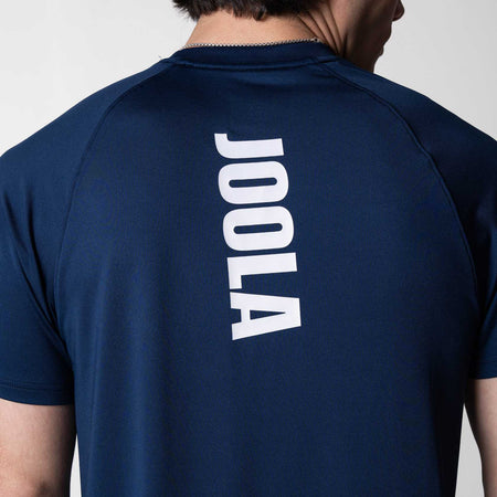 Close up on the white JOOLA brand logo that runs down the middle of the JOOLA Court Short Sleeve Shirt, Navy Blue.