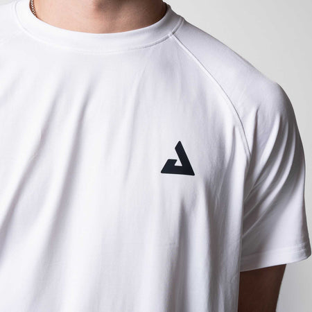 Close up on the black JOOLA Trinity logo on a white JOOLA Court Short Sleeve Shirt.