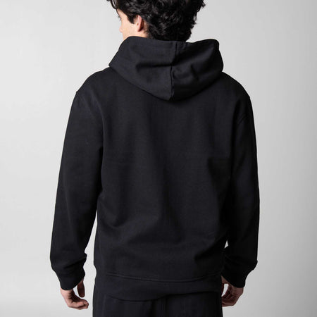 Gray background, image showing the back of a male model who is wearing the JOOLA Fleece Hoodie, Black.