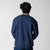 Gray background, image showning the back of a male model who is wearing the JOOLA Fleece Crew, Navy!