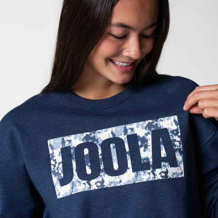 Close up on the JOOLA Camo logo on a blue JOOLA Crew Fleece, Navy.