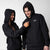 Two models wearing matching JOOLA Fleece Hoodies, Black.