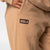 Close up on the JOOLA logo on a pair of JOOLA Fleece Pants, Latte.