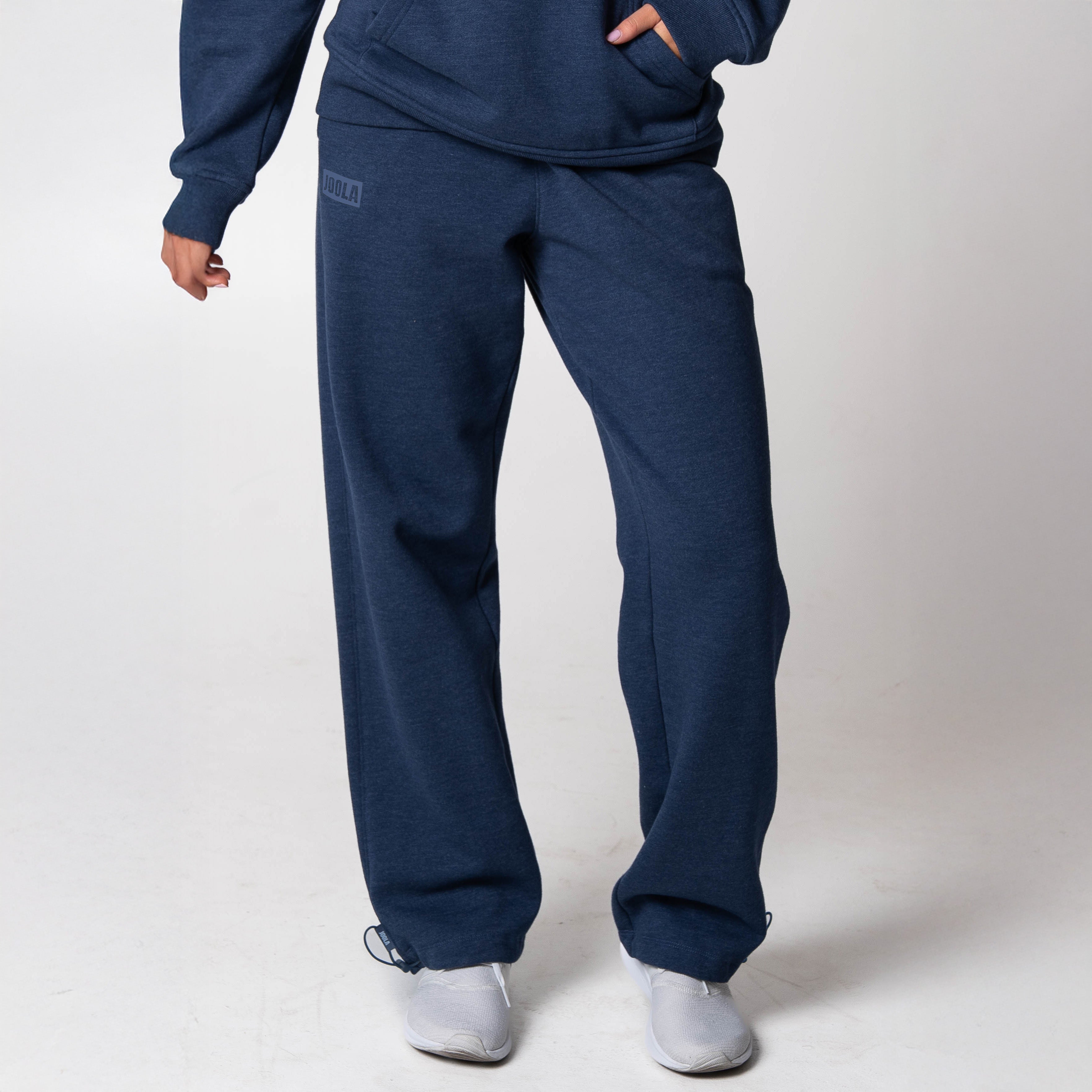 Gray background, image of a model wearing JOOLA Fleece pants (Navy).