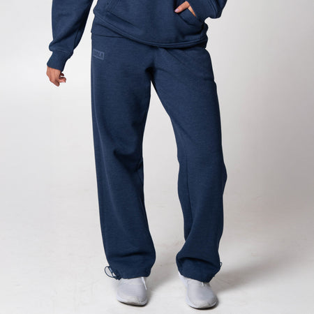 Gray background, image of a model wearing JOOLA Fleece pants (Navy).