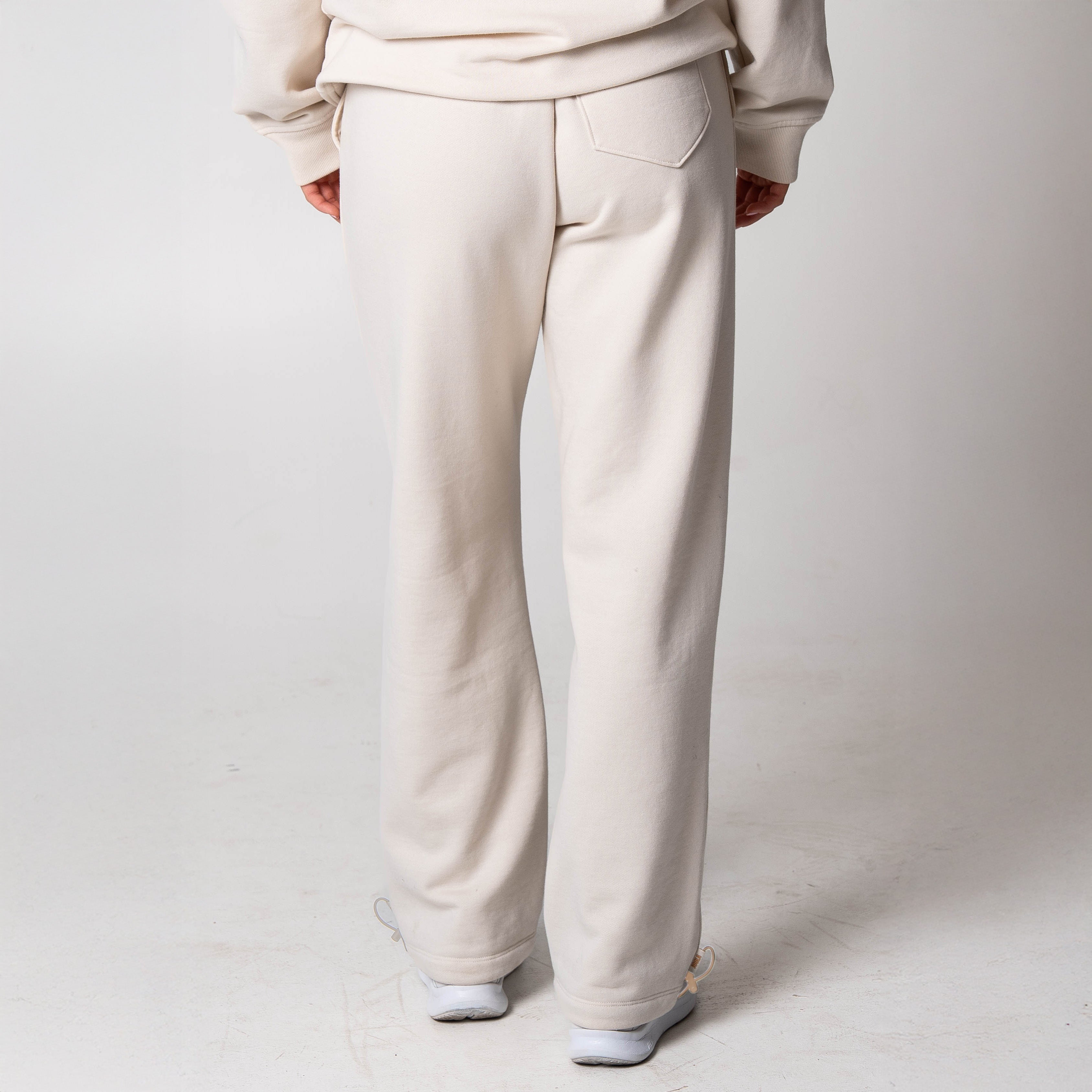 Gray background, image showing the back or a pair of JOOLA Fleece pants (Sandstone).