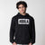Gray background, image of a male model wearing a JOOLA Graphic Hoodie, Black and White.