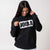 Gray background, female model wearing a JOOLA Graphic Hoodie, Black and White.