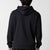 Gray background, image of the back of a male model who is wearing a black JOOLA Graphic hoodie.