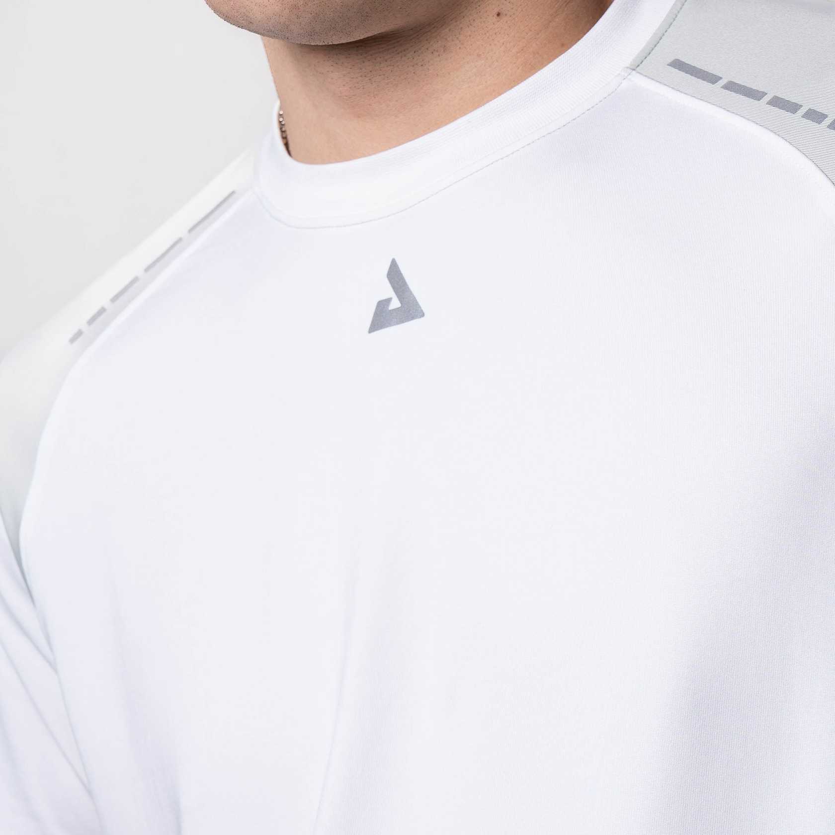 Close up of the JOOLA Trinity logo on a JOOLA Hybrid Short Sleeve White Shirt.