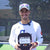 Ben Johns posing with customized Stand Up 2 cancer paddle.
