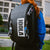 Person wearing a black backpack with JOOLA branding outdoors. Three different JOOLA Pro IV keychains.