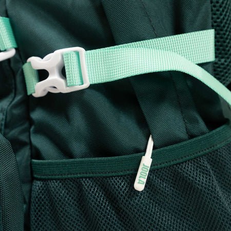 Close-up of a green JOOLA Utility backpack with a strap and white buckle.