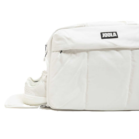 White background, white JOOLA branded bag with hidden shoe compartment pictured.