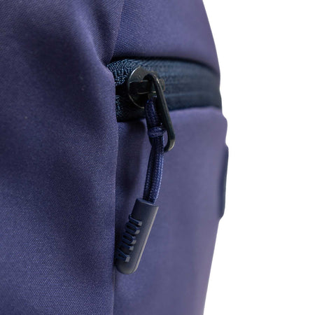 Close-up of a blue JOOLA backpack zipper on a white background